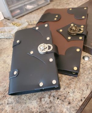 Small and Large Twistlock Journals on Workbench handmade by Red Falcon